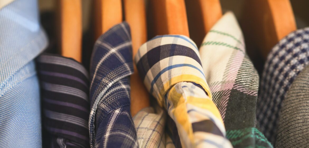 Man's closet hangers shirts closeup