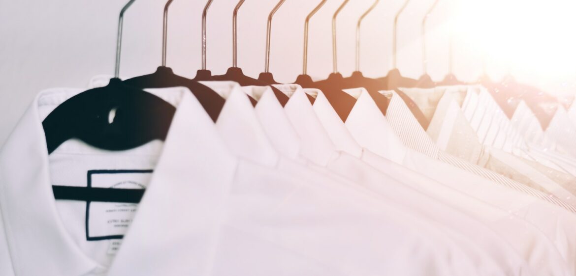 Organized white dress shirts on hangers