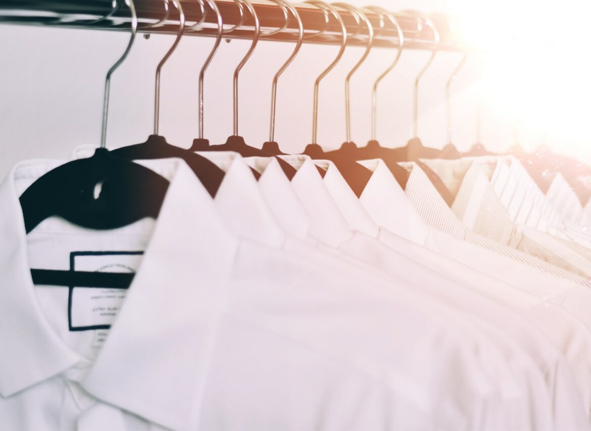 Organized white dress shirts on hangers