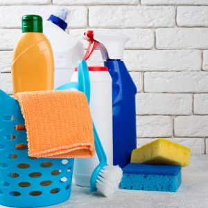 Basket with cleaning products on white background. Cleaning with supplies, cleaning service